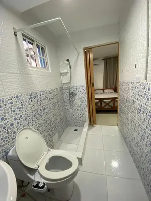 a bathroom with a toilet and a sink at Villa El cocotero in La Joya