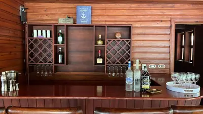 a bar with bottles of wine on a wooden wall at Villa Celeste Bed & Breakfast in El Río Arriba