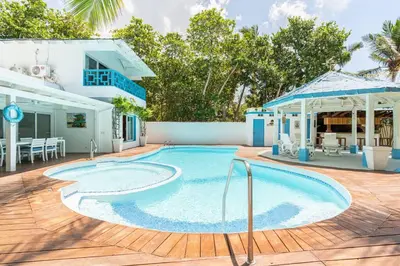 a swimming pool in front of a house at Dolce Casa in Juan Dolio