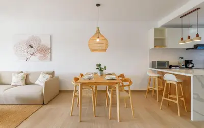a kitchen and living room with a table and a couch at New pool views Sausalito Residencial close to Playa Bavaro in Punta Cana