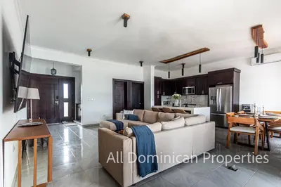 a living room with a couch and a table at Villas Santa Fe in Sosúa