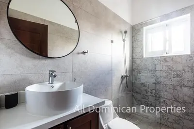 a bathroom with a white sink and a mirror at Villas Santa Fe in Sosúa