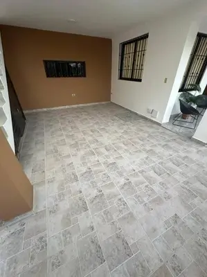 an empty room with a tiled floor in a house at Aire acondicionado Proximo teleférico y ocean Word in San Felipe de Puerto Plata