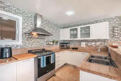 a kitchen with a sink and a stove top oven at Magnificent villa with ocean view in Puerto Bahia in Sabana