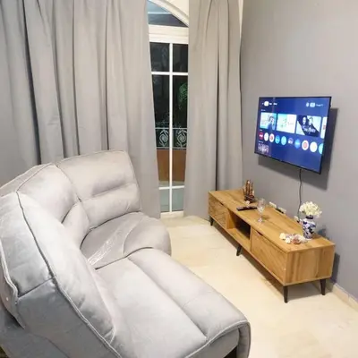 a living room with a chair and a tv at Juan Dolio,Beach, Pool, 40