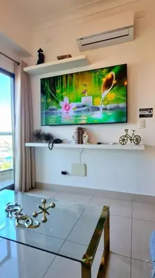 a room with a glass table and a painting on the wall at Luxury penthouse con jacuzzi privado, Gym, pool in Santo Domingo