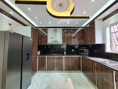 a large kitchen with wooden cabinets and a ceiling at Aparta hoteles Corales del Sur in La Viva