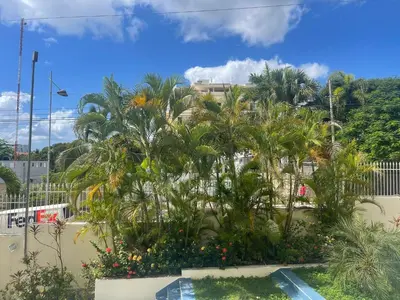 a group of palm trees in front of a building at Apartamento en la playa 1A - Residencial Marina Bay in Cuevas