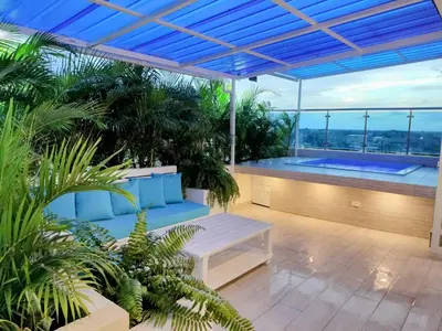 a patio with a bench and a swimming pool at Agréable appartement en rooftop in La Cabirma