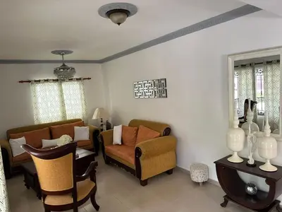 a living room with two chairs and a couch at Casa completa con hermosa vista in San Felipe de Puerto Plata
