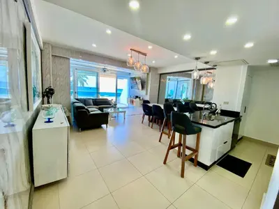 a living room with a kitchen and a dining room at LasOlasTower JuanDolio-2Br-3Bds-7Px-WiFi-SeaView in Juan Dolio