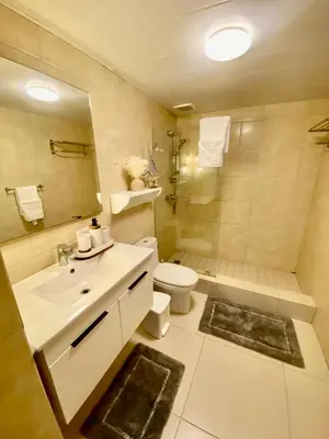 a bathroom with a sink and a toilet and a shower at LasOlasTower JuanDolio-2Br-3Bds-7Px-WiFi-SeaView in Juan Dolio