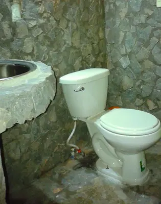 a bathroom with a white toilet and a sink at La Rancheta in Las Galeras