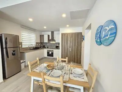 a kitchen and dining room with a table and chairs at Paradise 1BDR APT in front of Hard Rock Hotel in Punta Cana