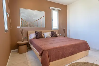 a bedroom with a bed with a bridge in the background at Villa Chocolate in Laguna del Higüero