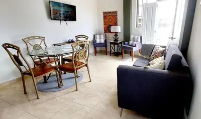 a living room with a table and a couch at Salomé in Sans Souci