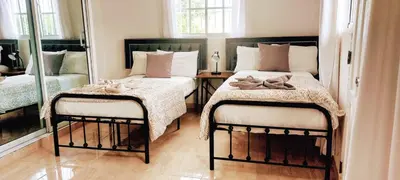 a bedroom with two beds and a mirror at Salomé in Sans Souci