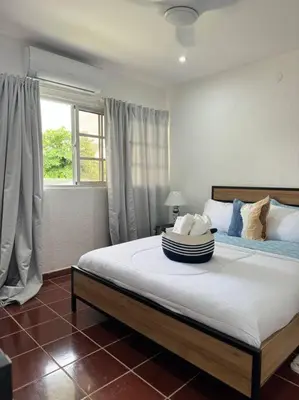a bedroom with a large bed with a window at Luz de Luna Emotions in Santo Domingo