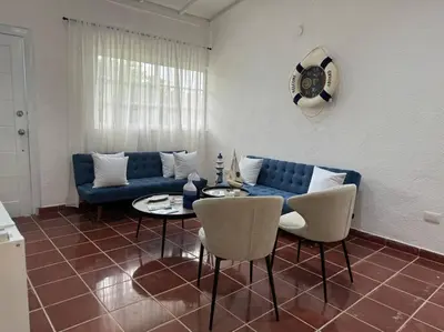 a living room with a blue couch and a table at Luz de Luna Emotions in Santo Domingo