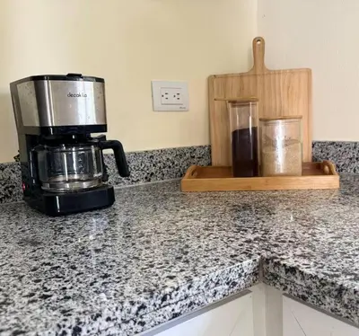 a counter top with a coffee maker and a coffee pot at Apartamento hermoso in Los Macos