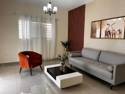 a living room with a couch and a chair at Apartamento hermoso in Los Macos