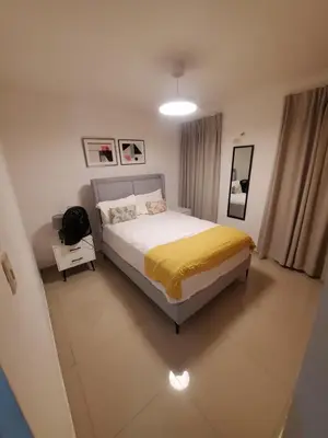 a bedroom with a bed with a yellow blanket at Lo mejor para descansar in Mendoza