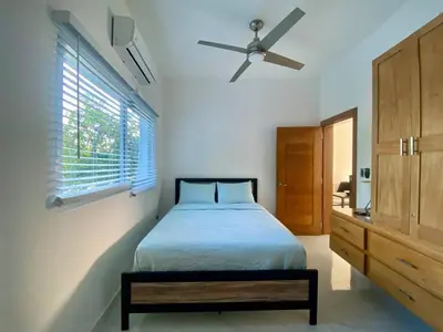 a bedroom with a bed and a ceiling fan at Fantástico apartamento céntrico Playa a 100 mts in Río San Juan