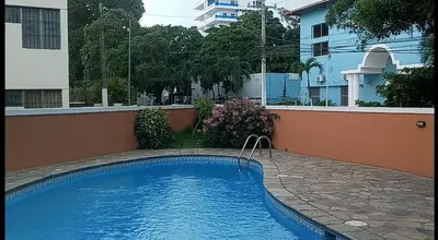 a swimming pool in front of a building at Residenzia Oasis Fiordaliza in El Higo