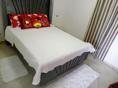 a bed with red pillows on it in a room at Residenzia Oasis Fiordaliza in El Higo