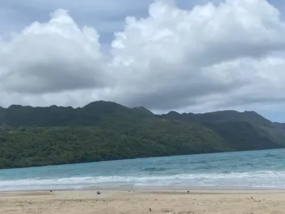 a beach with mountains in the background and the ocean at Vistas Galeras in Madama
