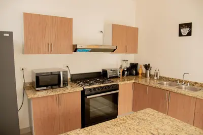 a kitchen with a microwave and a stove top oven at Vistas Galeras in Madama