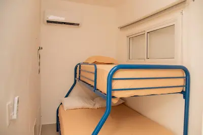 two bunk beds in a room with a window at Vistas Galeras in Madama