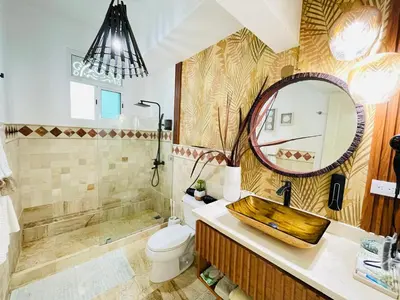 a bathroom with a sink and a toilet and a mirror at Victorian Condominio in Cabarete