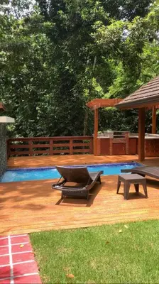 a swimming pool with a gazebo and a bench at Villa Reina in Buena Vista