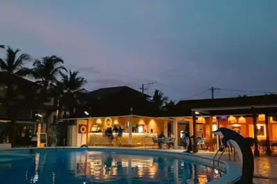 a swimming pool with an umbrella in front of a building at Eden 07 08 in La Laguna