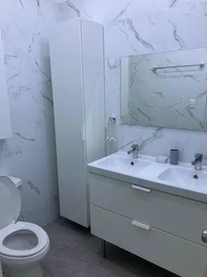 a white bathroom with a toilet and a mirror at Eden 07 08 in La Laguna