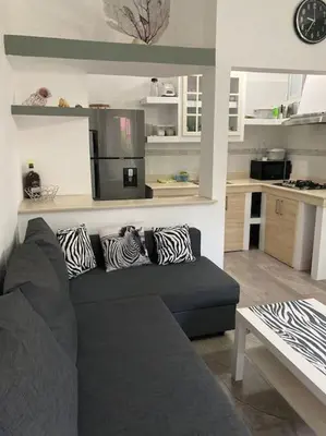 a living room with a couch and a kitchen at Eden 07 08 in La Laguna