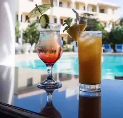 two cocktails sitting on a table next to a pool at Eden 07 08 in La Laguna
