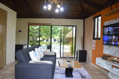 a living room with a couch and a table at Villa Doña Plinia in El Cruce