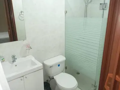 a bathroom with a toilet and a sink and a shower at 501 Apto Entero Stunning Malecón Roof Condo in Villa Francisca