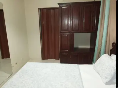 a bedroom with a bed and a wooden cabinet at 501 Apto Entero Stunning Malecón Roof Condo in Villa Francisca