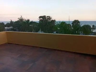 a yellow wall with a view of the ocean at 501 Apto Entero Stunning Malecón Roof Condo in Villa Francisca