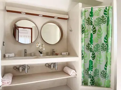 a bathroom with a sink and a mirror at Charming oceanside 2 bd villa in Cabarete