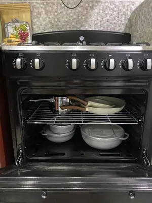 an oven with plates and pans sitting in it at Casa las América in La Cana