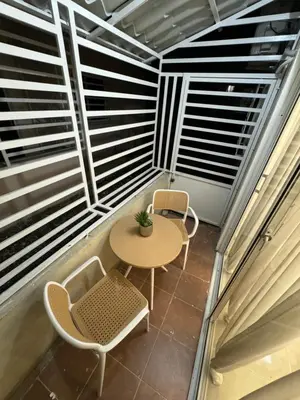 a small balcony with a table and two chairs at Casa las americas in La Cana