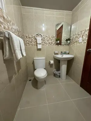 a bathroom with a toilet and a sink at Casa las americas in La Cana