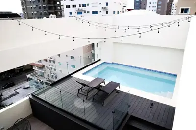 a swimming pool on the roof of a building at Departamento de lujo en Santo Domingo in Santo Domingo