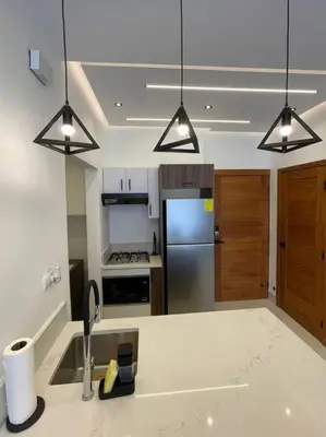 a kitchen with a sink and a refrigerator at Departamento de lujo en Santo Domingo in Santo Domingo