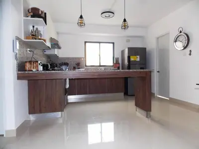 a large kitchen with a large wooden counter in a room at Cañaveral Del Mar 1 Quiet and extremally relaxing! in San Felipe de Puerto Plata