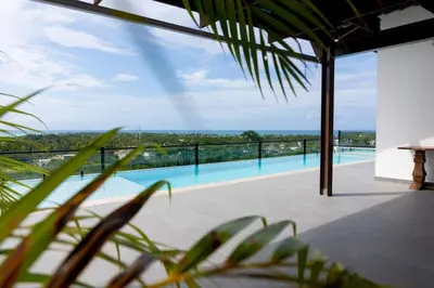 a view of a swimming pool from a house at New 2 BR apt with swimming pool at playa bonita in Las Terrenas